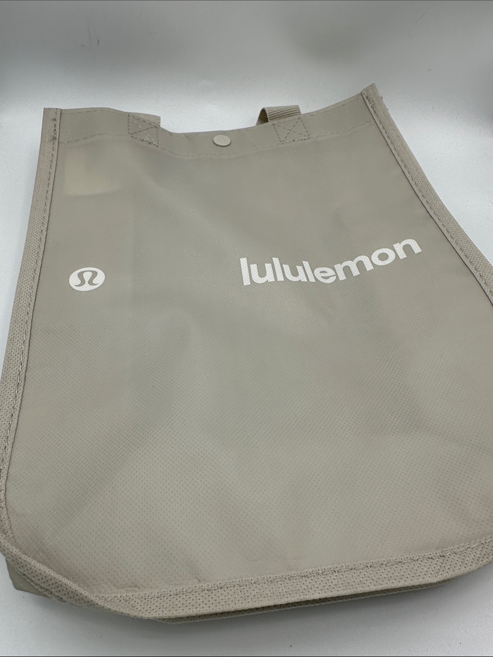 Lululemon light gray reusable shopping tote bag with prominent white logo